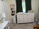 Bright bedroom featuring a white dresser and tasteful decor near a window with dark curtains at 101 E Hill Valley E Dr, Indianapolis, IN 46227