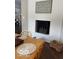 Cozy indoor fireplace with a decorative sign and shiplap. Woven table setting and hardwood floors at 101 E Hill Valley E Dr, Indianapolis, IN 46227