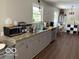Kitchen featuring granite counters, grey cabinets, stainless appliances, hardwood floors, and an eat-in area at 101 E Hill Valley E Dr, Indianapolis, IN 46227