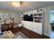 Inviting living room featuring built-in storage, a large TV, a chandelier, and natural lighting. Hardwood floors at 101 E Hill Valley E Dr, Indianapolis, IN 46227