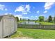 Backyard with lake views, shed, and wooden fence at 10693 Newgate Ln, Indianapolis, IN 46231