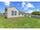 View of the home's backyard featuring a lawn, deck, storage shed, and wood fence at 10693 Newgate Ln, Indianapolis, IN 46231