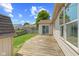 Backyard features a shed, wooden deck, and grass with a sunny sky above at 10693 Newgate Ln, Indianapolis, IN 46231