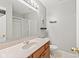 Well-lit bathroom with a single sink vanity and a shower with sliding glass doors at 10693 Newgate Ln, Indianapolis, IN 46231