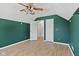 Bright bedroom with hardwood floors, window, vaulted ceilings, and neutral paint at 10693 Newgate Ln, Indianapolis, IN 46231
