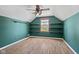 Bright bedroom with hardwood floors, window, built-in shelves and vaulted ceilings at 10693 Newgate Ln, Indianapolis, IN 46231