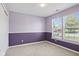 Bright bedroom with stylish two-toned walls, carpet flooring, and double windows at 10693 Newgate Ln, Indianapolis, IN 46231