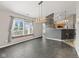 Open dining area with tile flooring, stylish lighting, and a breakfast bar leading to the kitchen at 10693 Newgate Ln, Indianapolis, IN 46231