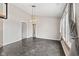 Dining room featuring ceramic tile floors, a modern chandelier, and lots of natural light at 10693 Newgate Ln, Indianapolis, IN 46231