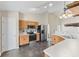 Kitchen with stainless steel appliances, light wood cabinets, and dark ceramic tile flooring at 10693 Newgate Ln, Indianapolis, IN 46231