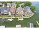 Stunning aerial view of waterfront homes with private docks and lush landscaping on a serene lake at 11244 Blackwalnut Pt, Indianapolis, IN 46236