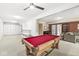 Basement featuring neutral colored walls and carpet with a billiards table and built-in storage at 11244 Blackwalnut Pt, Indianapolis, IN 46236