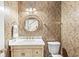 Stylish half bathroom featuring elegant wallpaper, marble countertop, and modern fixtures at 11244 Blackwalnut Pt, Indianapolis, IN 46236