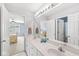 Bathroom featuring double sinks with a long mirror and views into two separate bedrooms at 11244 Blackwalnut Pt, Indianapolis, IN 46236