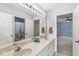 Bathroom featuring double sinks with a long mirror and views into two separate bedrooms at 11244 Blackwalnut Pt, Indianapolis, IN 46236