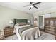 Cozy bedroom featuring a decorative rug, a ceiling fan, and a wooden wardrobe at 11244 Blackwalnut Pt, Indianapolis, IN 46236