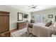 Relaxing bedroom with neutral tones, a ceiling fan, a dresser with mirror, and french doors at 11244 Blackwalnut Pt, Indianapolis, IN 46236