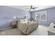 Serene bedroom with a metal bed frame, ceiling fan, and a view of the outdoors at 11244 Blackwalnut Pt, Indianapolis, IN 46236