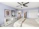 Bedroom featuring a ceiling fan, accent wall color, and view to other rooms at 11244 Blackwalnut Pt, Indianapolis, IN 46236