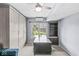 Well-lit bedroom showcasing custom storage solutions, desk space, and a peaceful view of the backyard at 11244 Blackwalnut Pt, Indianapolis, IN 46236