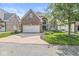 Traditional brick home with a two-car garage, driveway and manicured lawn in a suburban setting at 11244 Blackwalnut Pt, Indianapolis, IN 46236
