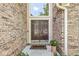 Inviting brick entryway featuring double doors, beautiful sidelights, and stylish outdoor lighting at 11244 Blackwalnut Pt, Indianapolis, IN 46236