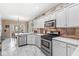 Modern kitchen featuring stainless steel appliances, white cabinets, and marble flooring at 11244 Blackwalnut Pt, Indianapolis, IN 46236