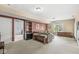Living room with neutral walls and carpet with a couch and an adjacent storage room at 11244 Blackwalnut Pt, Indianapolis, IN 46236