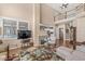 Spacious living room featuring a fireplace, high ceilings, and an adjacent kitchen at 11244 Blackwalnut Pt, Indianapolis, IN 46236