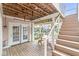 Covered patio with picnic table and stairs to upper deck and waterfront access at 11244 Blackwalnut Pt, Indianapolis, IN 46236