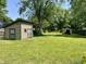 Large backyard featuring green grass, mature trees, and a shed at 1129 Nantucket Dr, Cicero, IN 46034