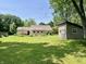 Expansive backyard with a house and shed surrounded by a lush green lawn at 1129 Nantucket Dr, Cicero, IN 46034