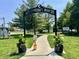 A welcoming community park featuring an archway entrance, walking path, and lush green spaces at 1129 Nantucket Dr, Cicero, IN 46034