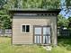 Modern shed with horizontal siding, a window, and unique door at 1129 Nantucket Dr, Cicero, IN 46034
