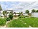 Beautiful backyard with decorative landscaping, including mature trees and stepping stones at 121 Mulberry Dr, Chesterfield, IN 46017