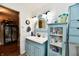Bathroom featuring a blue vanity, decorative mirror, and stylish fixtures at 121 Mulberry Dr, Chesterfield, IN 46017