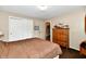 Cozy bedroom features neutral walls, closet, and a wooden dresser at 121 Mulberry Dr, Chesterfield, IN 46017