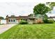 Charming single-story home with well-manicured lawn and inviting front porch at 121 Mulberry Dr, Chesterfield, IN 46017
