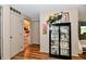Hallway with wood-look floors and a display cabinet leading to the bedroom and living area at 121 Mulberry Dr, Chesterfield, IN 46017