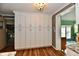 Kitchen showcasing ample white cabinetry, wood-look flooring, and decorative crown molding at 121 Mulberry Dr, Chesterfield, IN 46017
