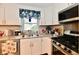 Functional kitchen space with floral accents, stainless steel appliances, and white cabinetry at 121 Mulberry Dr, Chesterfield, IN 46017
