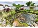 Beautiful koi pond with water plants, fish, and rock edging at 121 Mulberry Dr, Chesterfield, IN 46017
