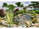 Backyard garden with a serene pond featuring colorful koi fish and aquatic plants at 121 Mulberry Dr, Chesterfield, IN 46017