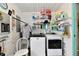 Functional laundry room featuring white appliances, wire shelving, and rustic decor for an organized, charming space at 121 Mulberry Dr, Chesterfield, IN 46017