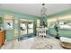 Living area with mint walls, access to the patio, and a dining area with natural light at 121 Mulberry Dr, Chesterfield, IN 46017
