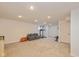 Spacious basement featuring plush carpeting, recessed lighting and ample open space for recreation and fitness equipment at 12772 Tram Ln, Carmel, IN 46032