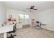 Bright bedroom with carpet and ceiling fan; featuring 2 desks and neutral-colored walls at 12772 Tram Ln, Carmel, IN 46032