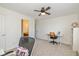 Bright bedroom with light-colored carpet, ceiling fan, and view into an ensuite bath at 12772 Tram Ln, Carmel, IN 46032