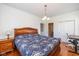 Inviting bedroom with wood floors, a desk, and a decorative comforter on the bed at 12772 Tram Ln, Carmel, IN 46032