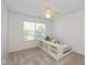 Bedroom with light-colored walls and carpet, featuring a ceiling fan and window for natural light at 12772 Tram Ln, Carmel, IN 46032